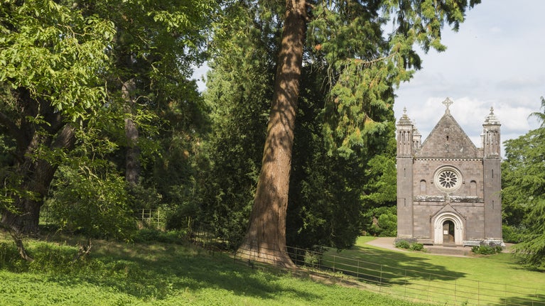 The Victorian chapel surrounded by tall trees